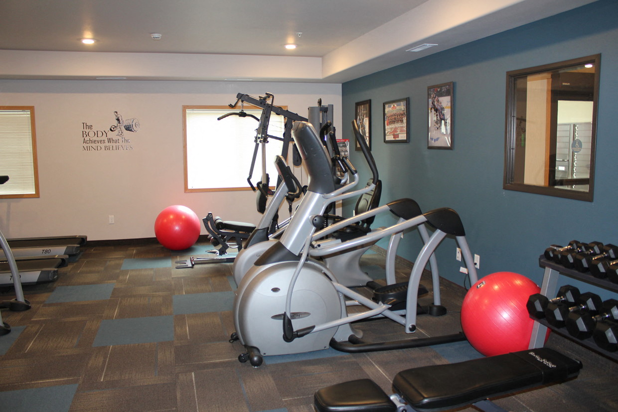 a gym with a bunch of exercise equipment in it