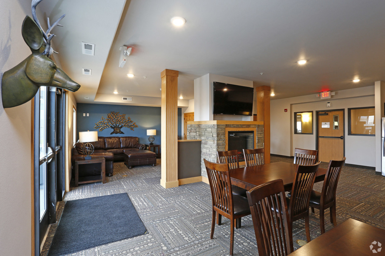 a living room with a table and chairs and a fireplace