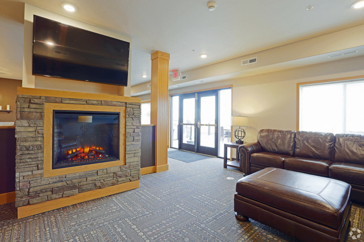 a living room with a fireplace and leather furniture