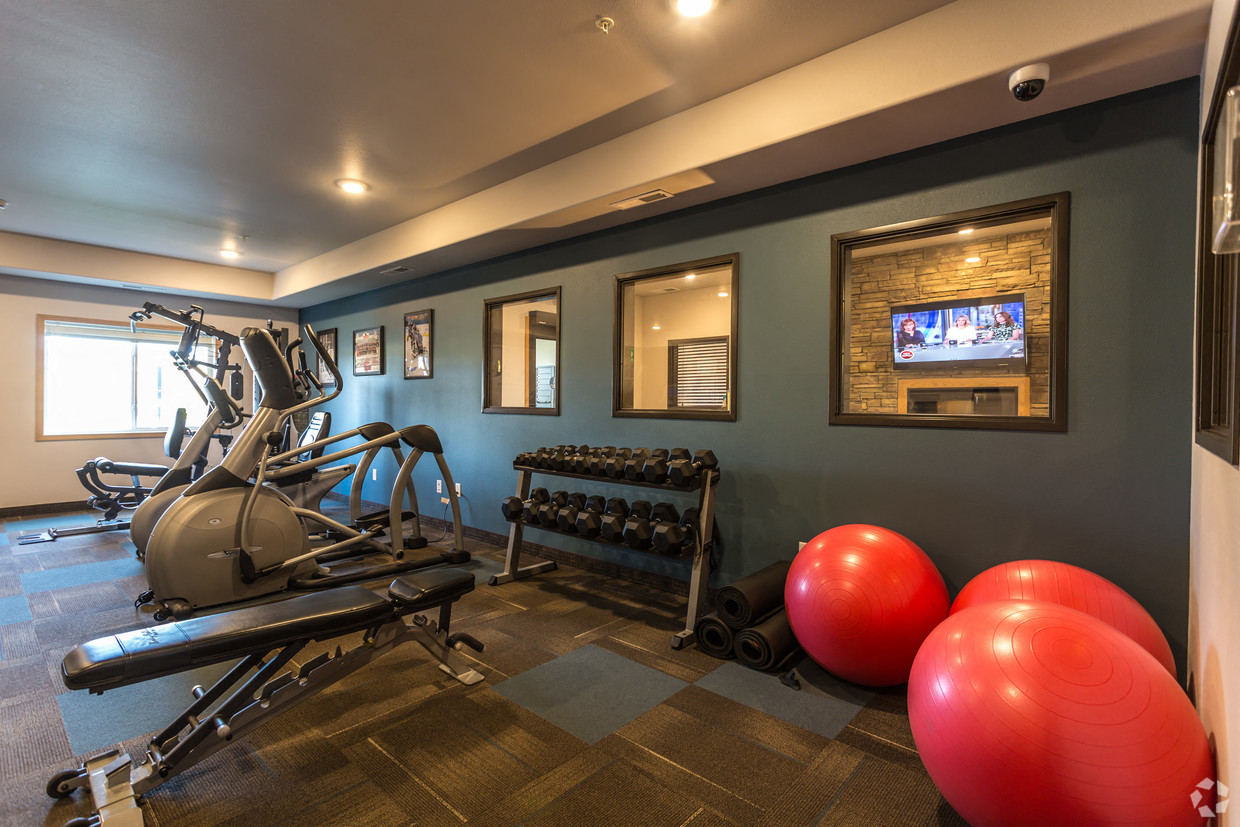 a home gym with exercise equipment and a television