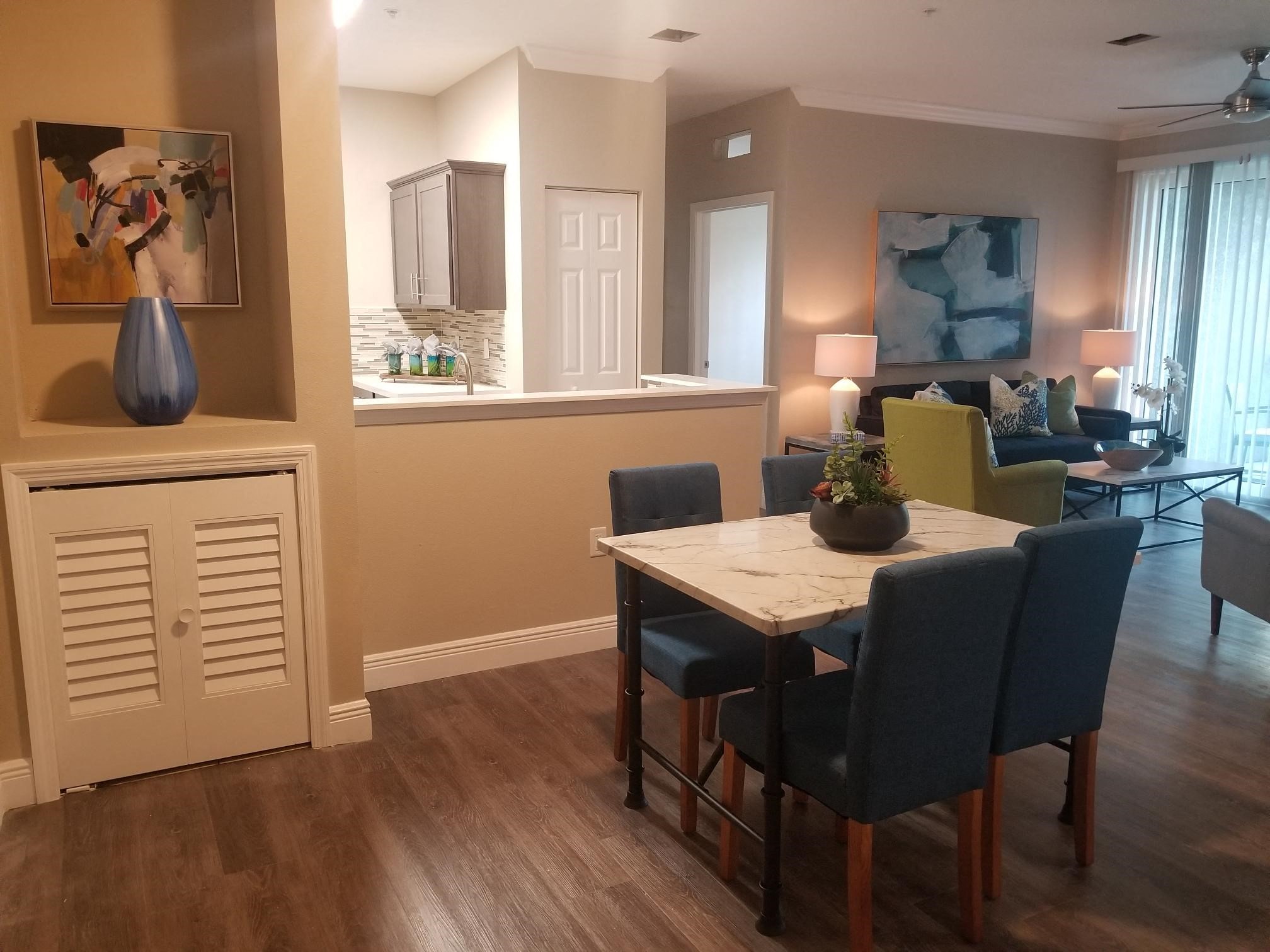 a dining room and living room area with a table and chairs and a living room
