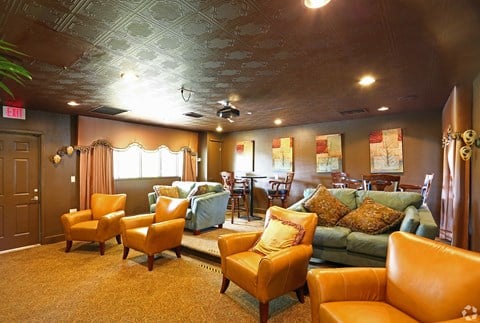 a large living room with couches and chairs