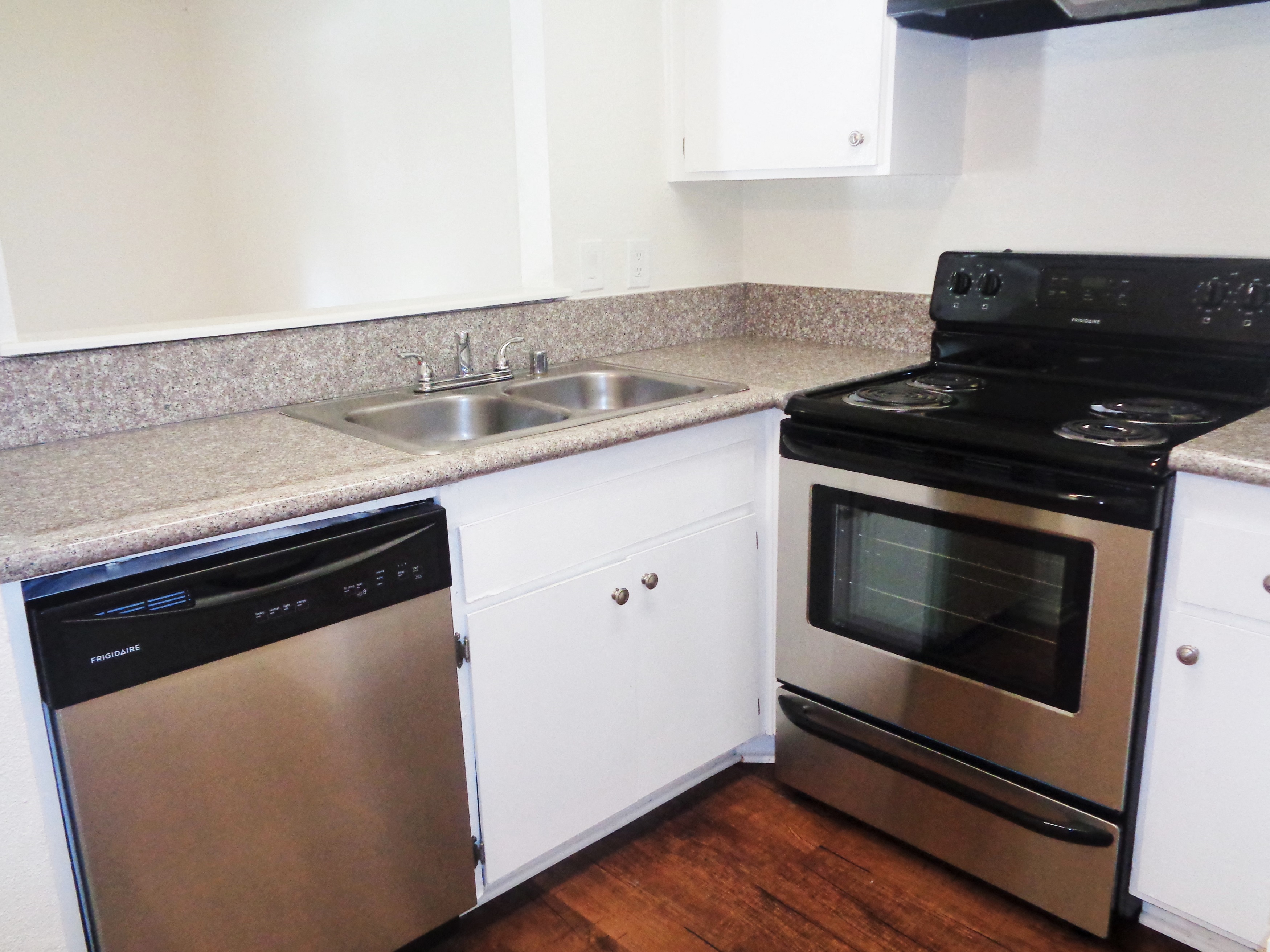 a kitchen with stainless steel appliances and white cabinets