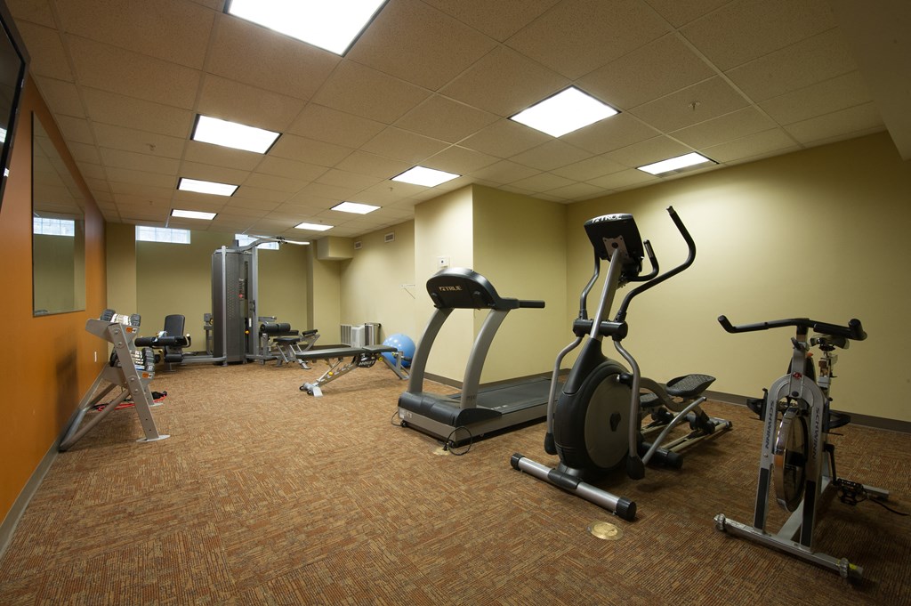 a gym with various exercise equipment in a large room