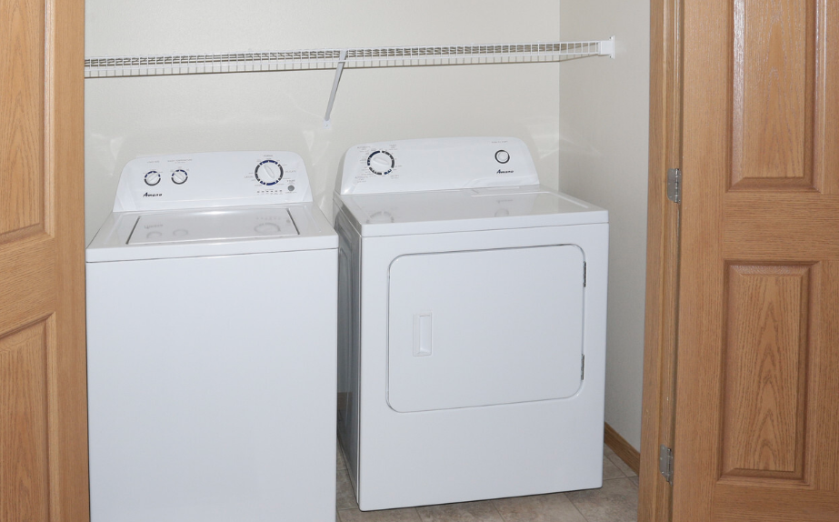 a washer and dryer in a laundry room with a door