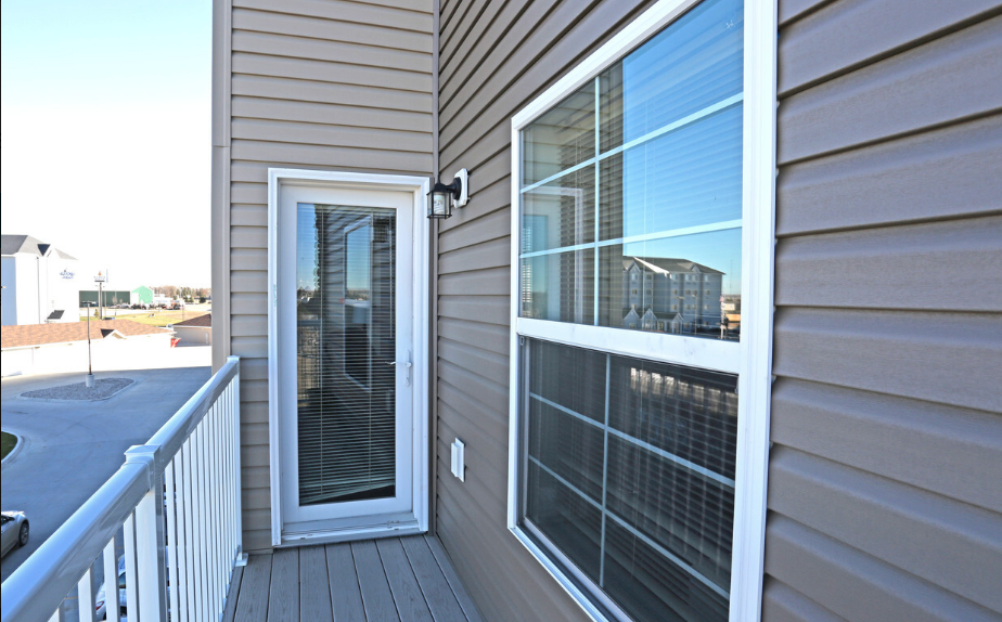 the view of the balcony from the front door of a home
