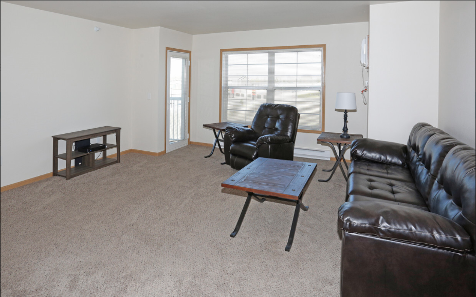a living room with leather furniture and a coffee table