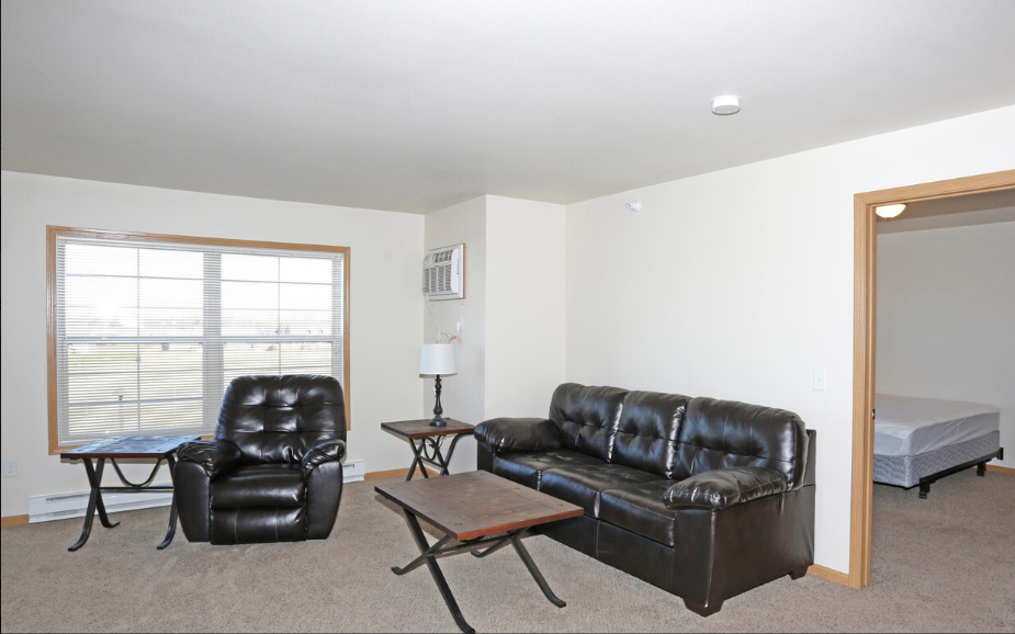 a living room with leather couches and a coffee table