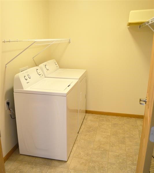 a washer and dryer in a room with a closet