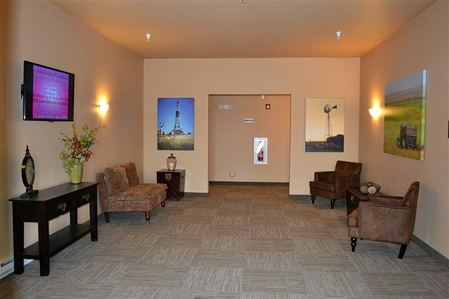 a large living room with chairs and a tv