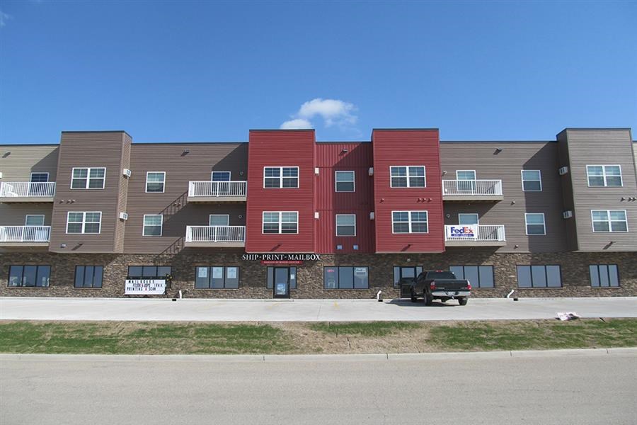 an apartment building with a truck parked in front of it