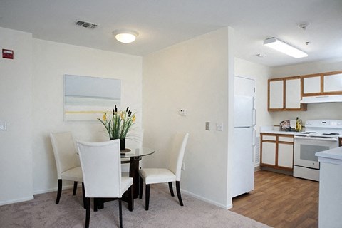 a kitchen and dining room with a table and chairs