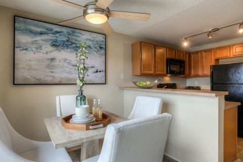 a kitchen and dining room with a table and chairs