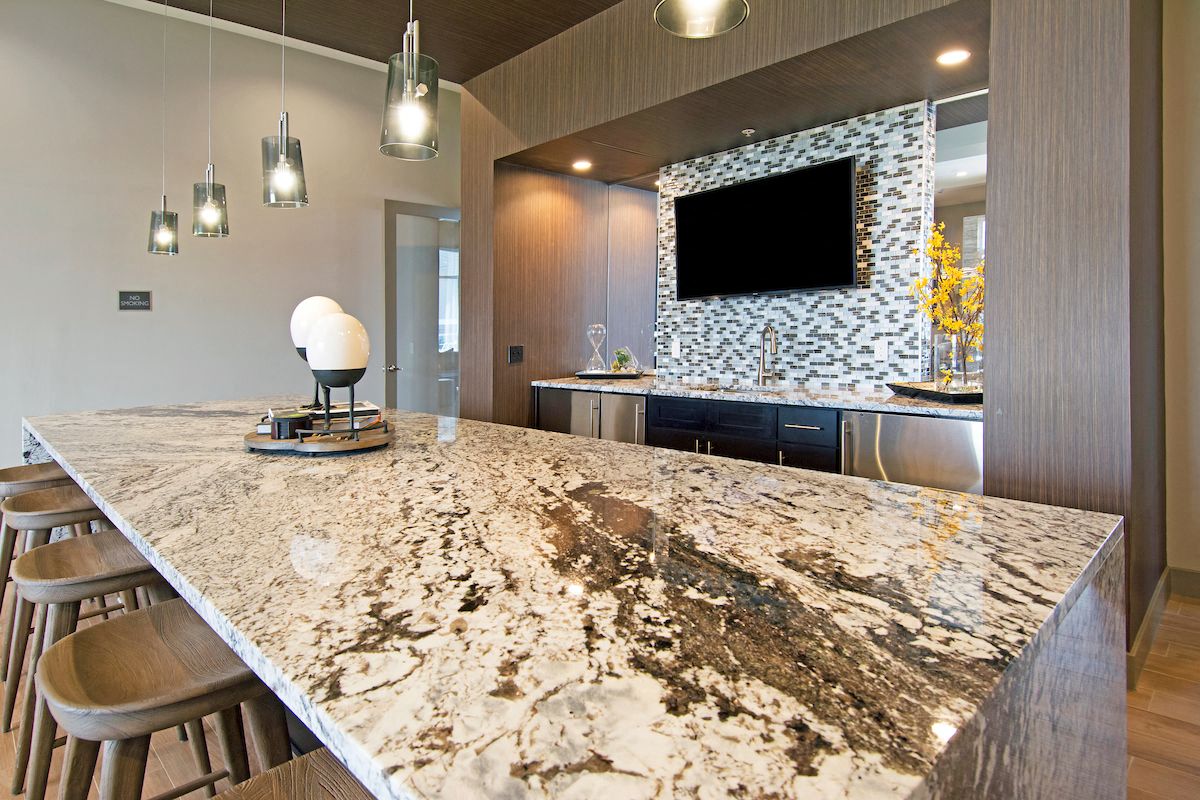 a kitchen with a large counter top and a tv