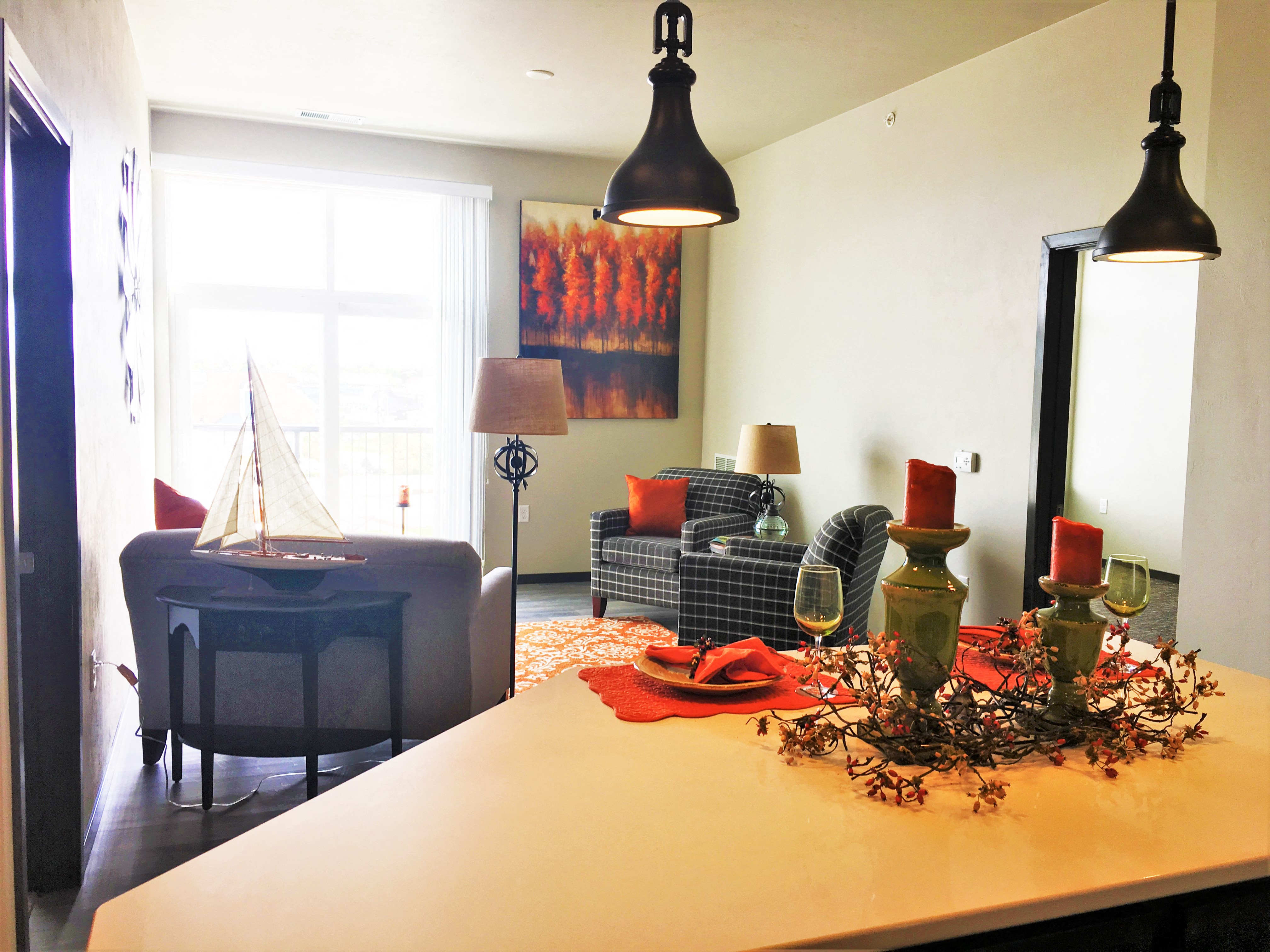 a living room and dining room with a table with decorations on it