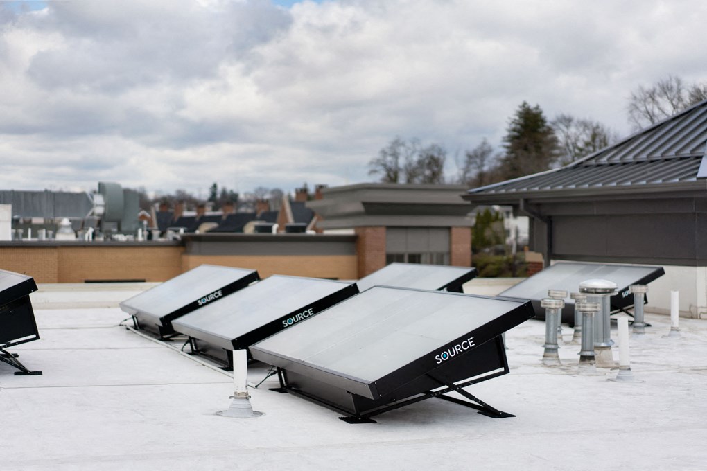 a row of cooling units on the roof of a building