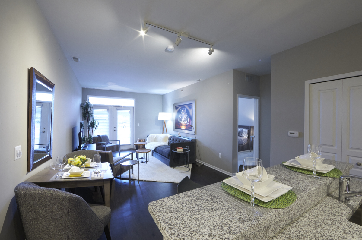 a living room and dining room with a couch and a table