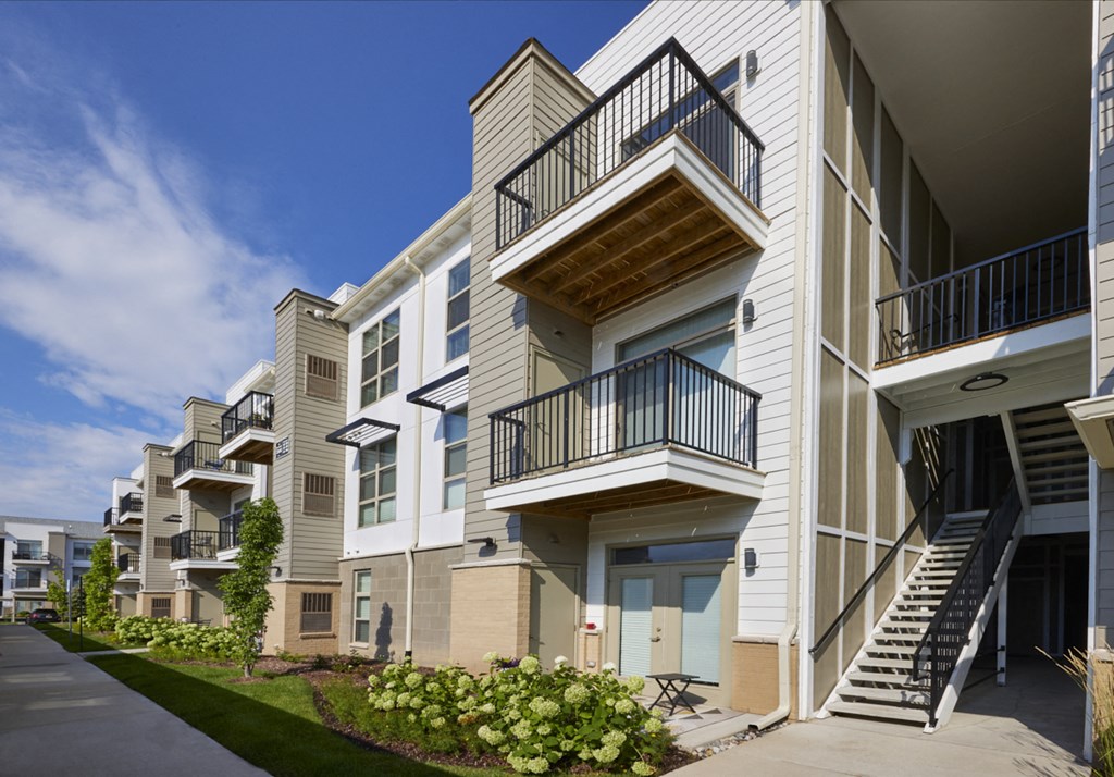a row of apartment buildings with balconies and stairs