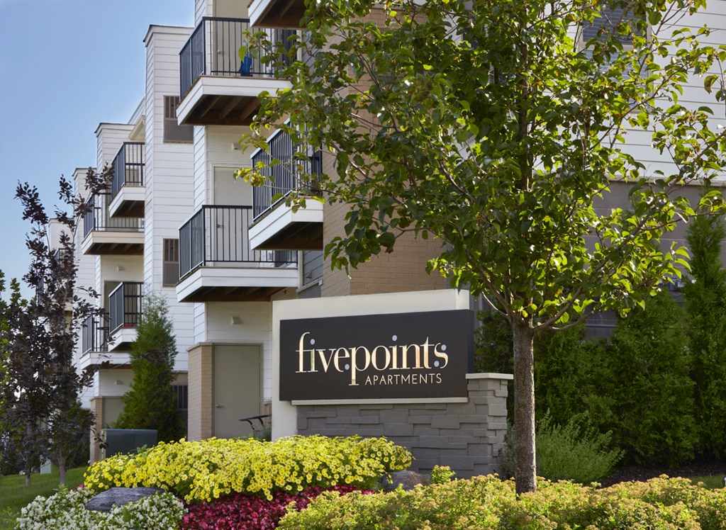 an apartment building with a sign for five points apartments