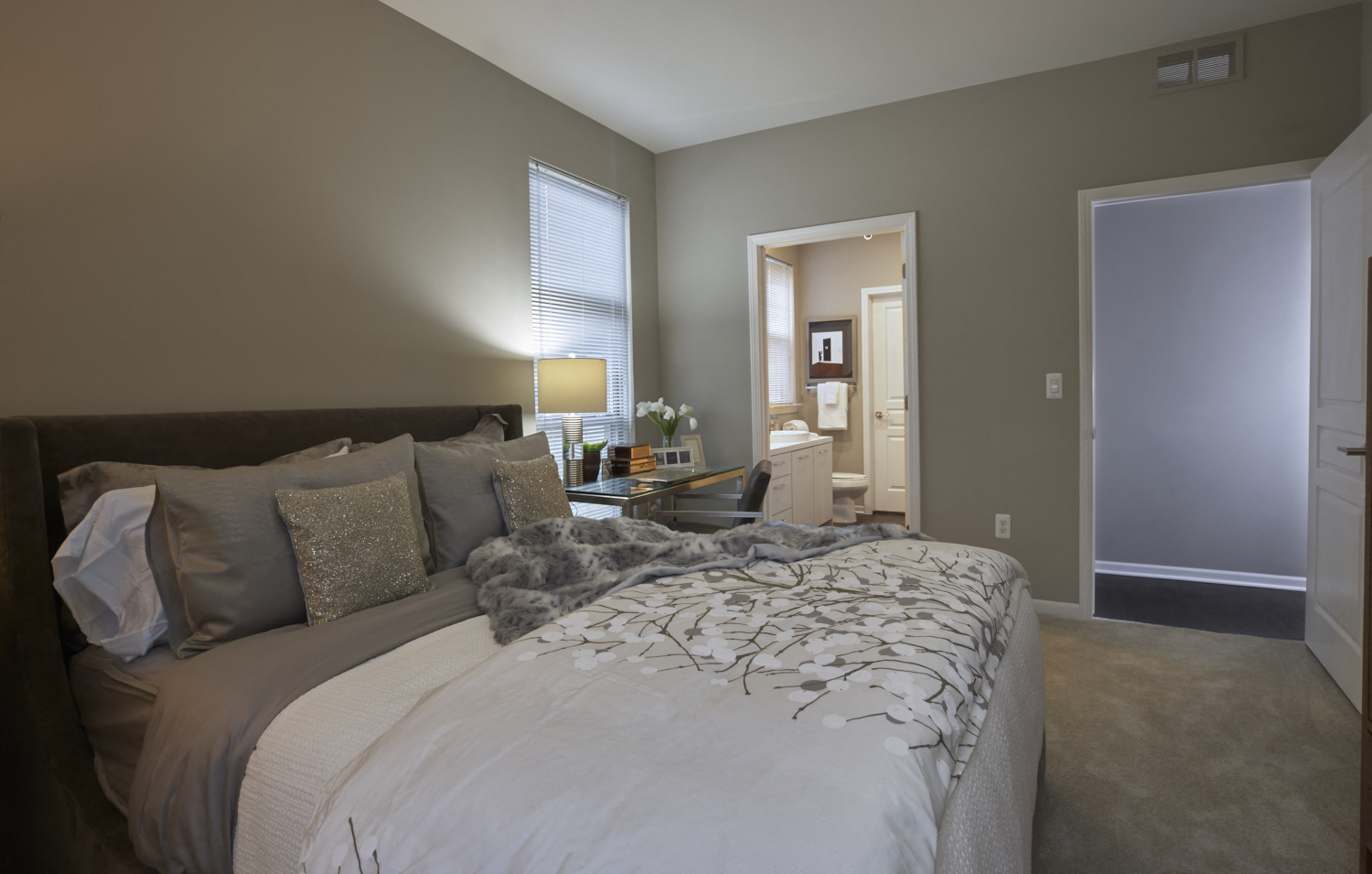 a bedroom with a large bed and a bathroom