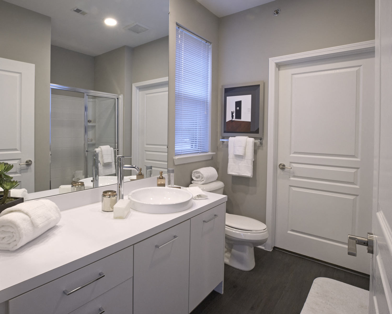 a white bathroom with a sink and a toilet
