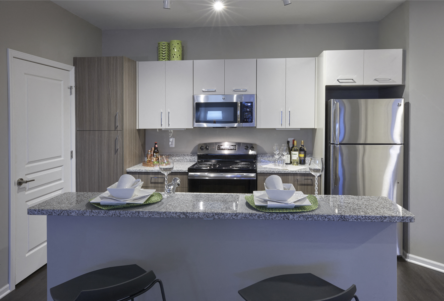 a kitchen with granite counter tops and stainless steel appliances