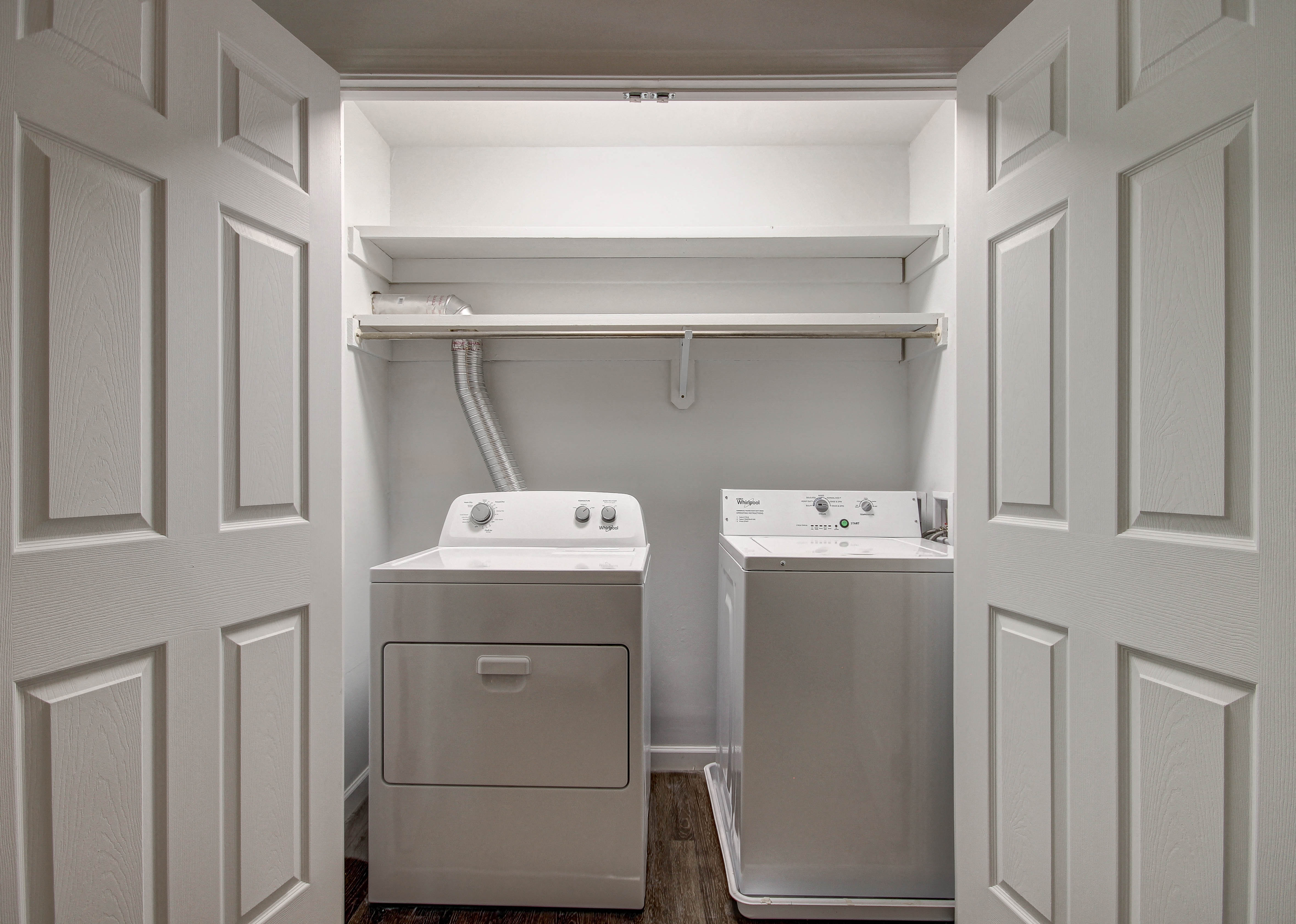 a washer and dryer in a laundry room with white doors