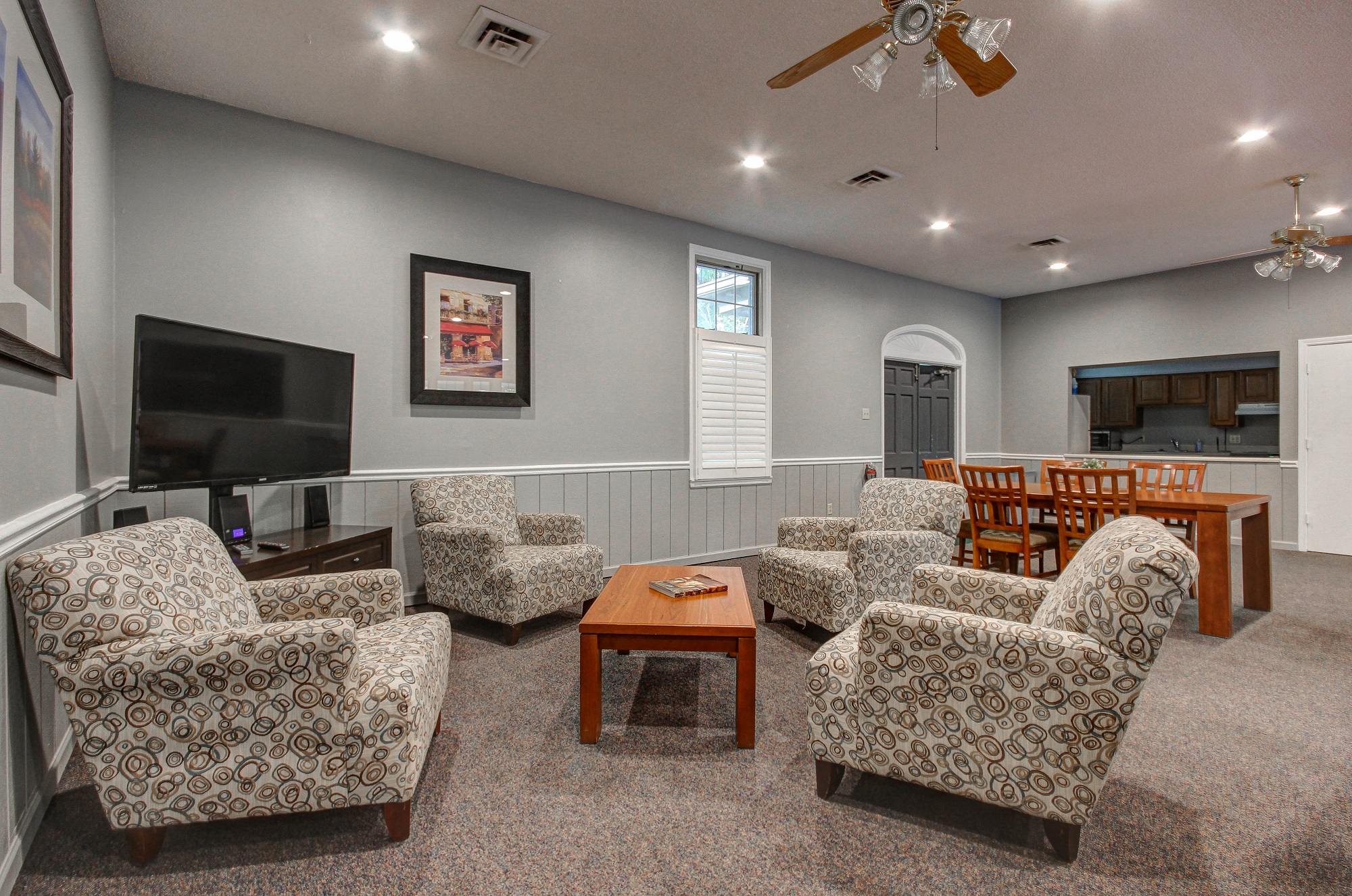 a living room with couches and a table and a television
