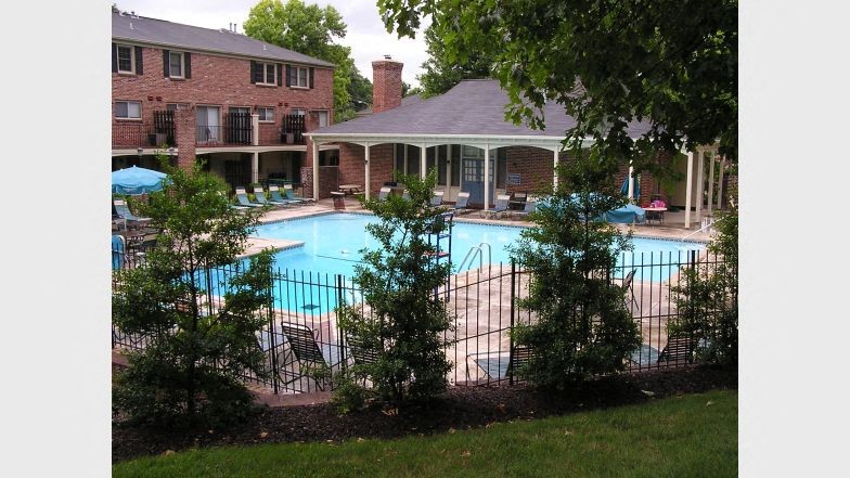 a large swimming pool in front of a house