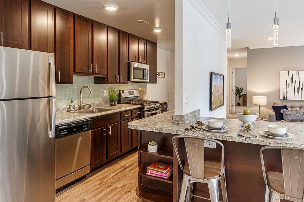 a kitchen with stainless steel appliances and granite counter tops