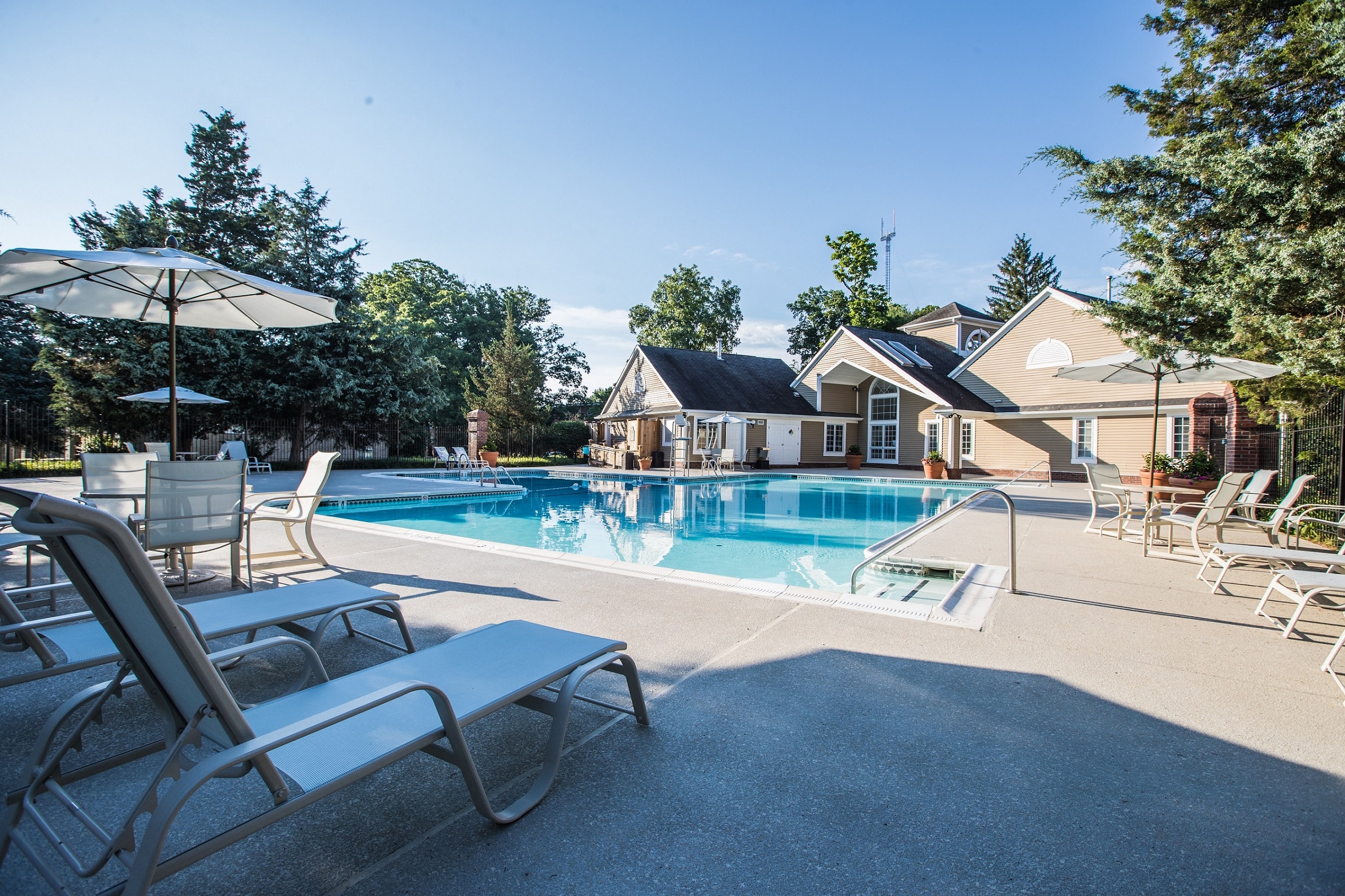 our apartments have a large pool with chairs and umbrellas