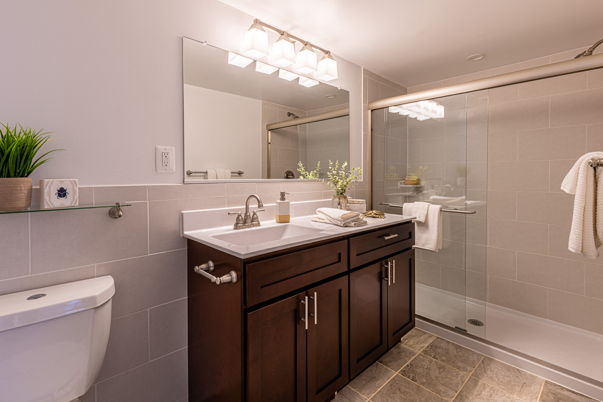 a bathroom with a sink and a shower and a toilet