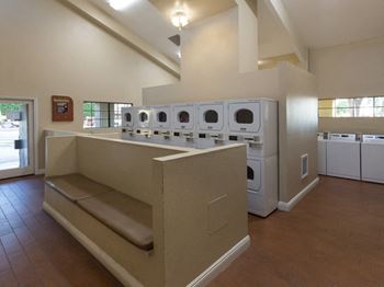 El Encanto shared laundry unit with standard washer and dryers. 