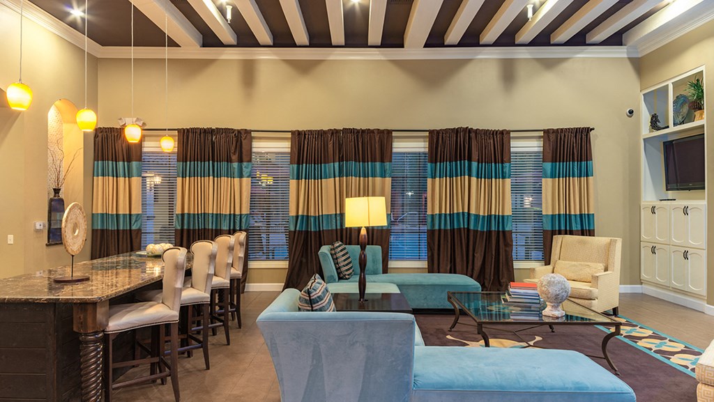 a living room filled with furniture and a large window