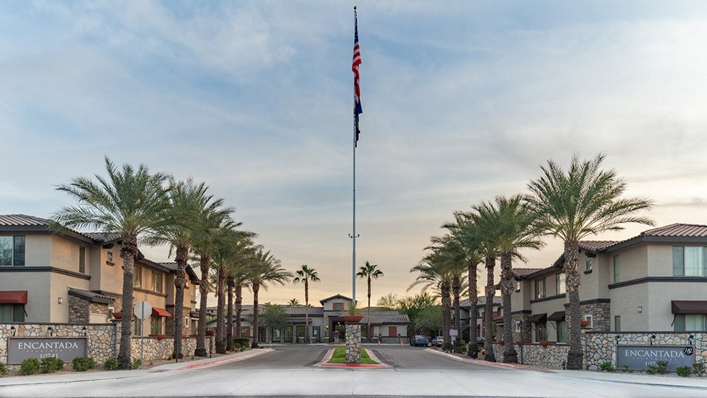 a flag pole with an american flag at the end of a street
