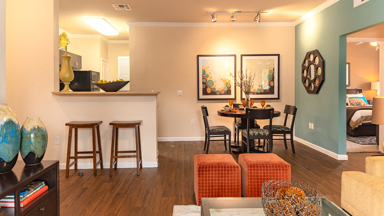 a living and dining room area with a table and chairs