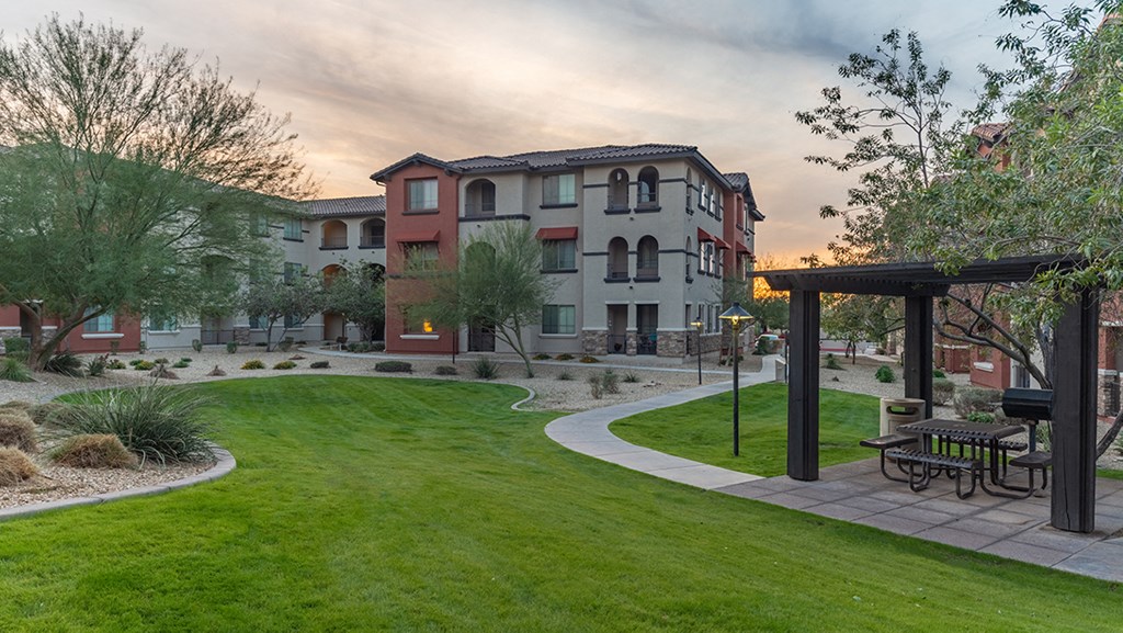 a park with a picnic table in the middle of a grassy area