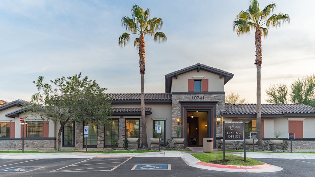 a building with two palm trees in front of it