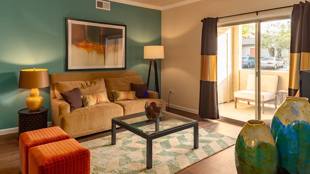 a living room with green walls and a brown couch