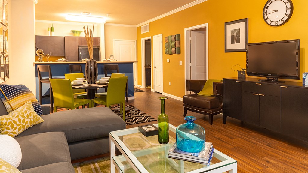 a living room with a couch and chair and a coffee table with a vase on it