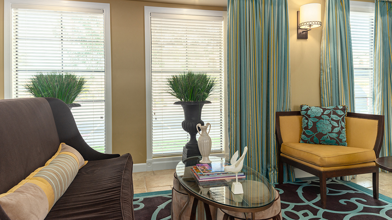 a living room filled with furniture and a large window