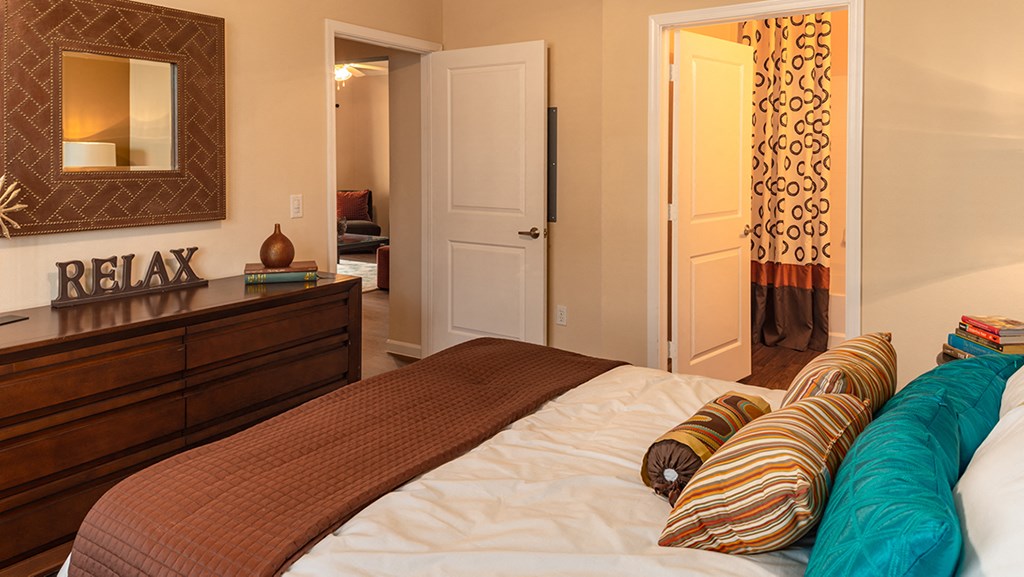 a bedroom with a bed and a dresser