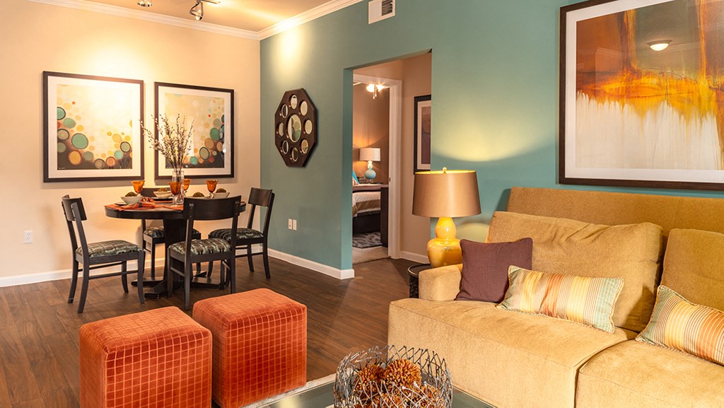 a living room with blue walls and orange furniture
