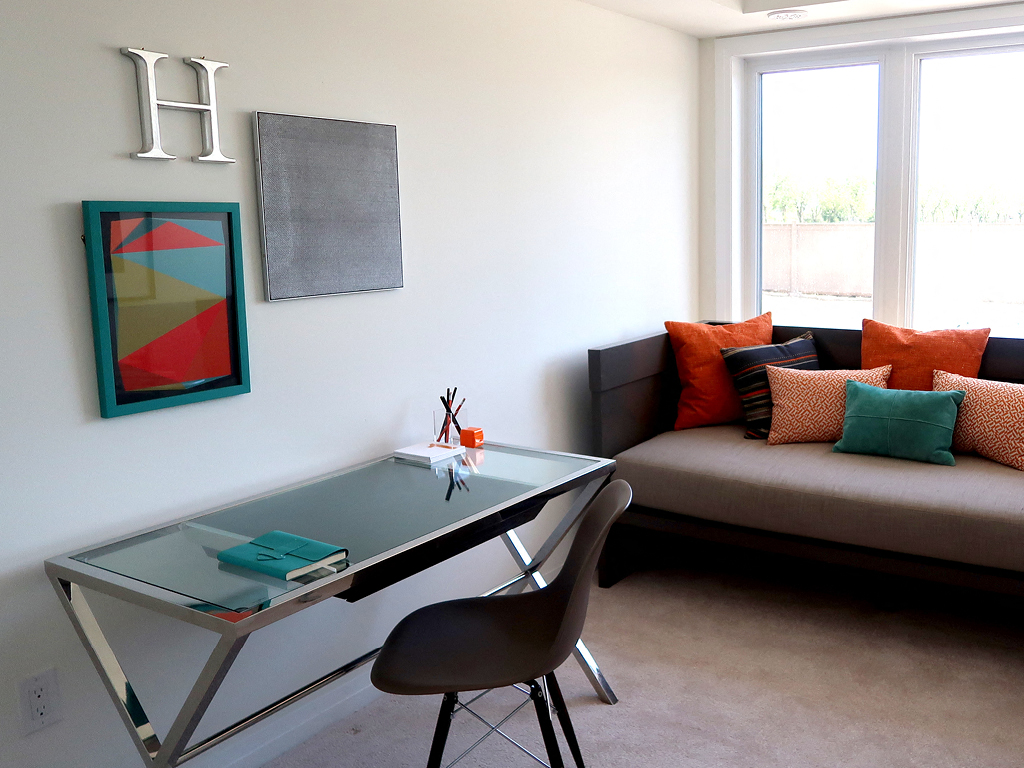 Living Room with Office Desk and Couch and Wall Art