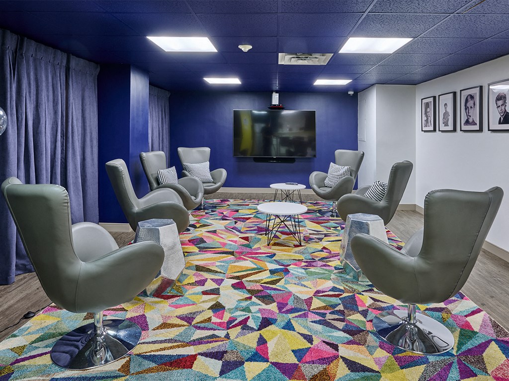 a large room with chairs and a television in it