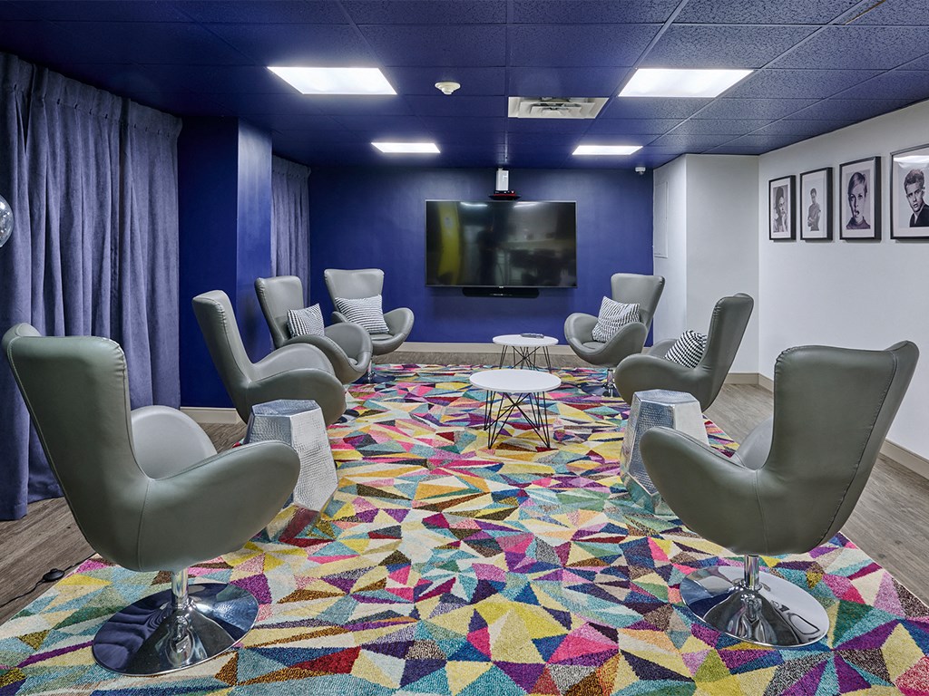 a large room with chairs and a television in it