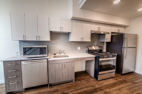 a kitchen with stainless steel appliances and white cabinets