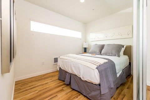 a bedroom with a bed and a window