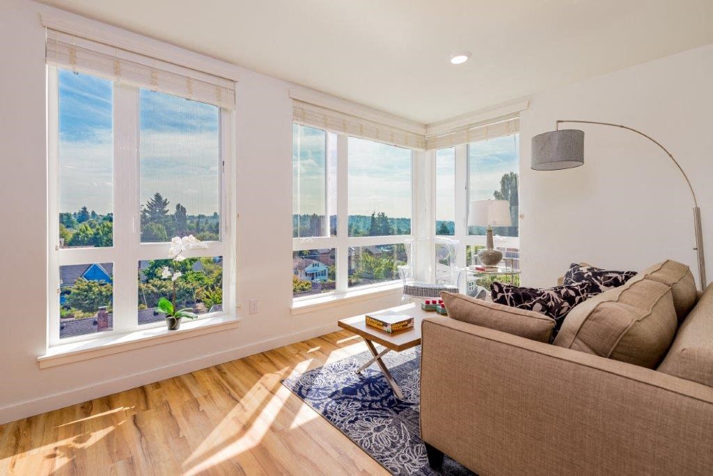 a living room with a couch and many windows