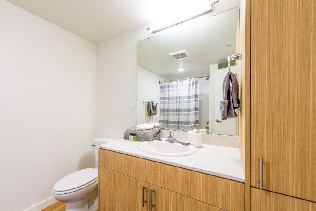 a bathroom with a sink toilet and a mirror